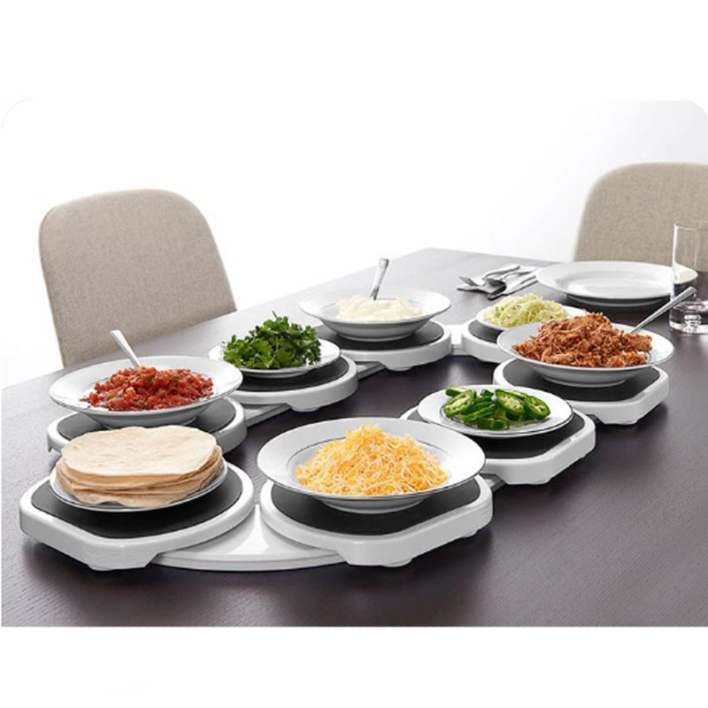 Table with multiple plates of food on a white background