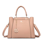 Beige handbag with a gold chain and kangaroo logo on a white background