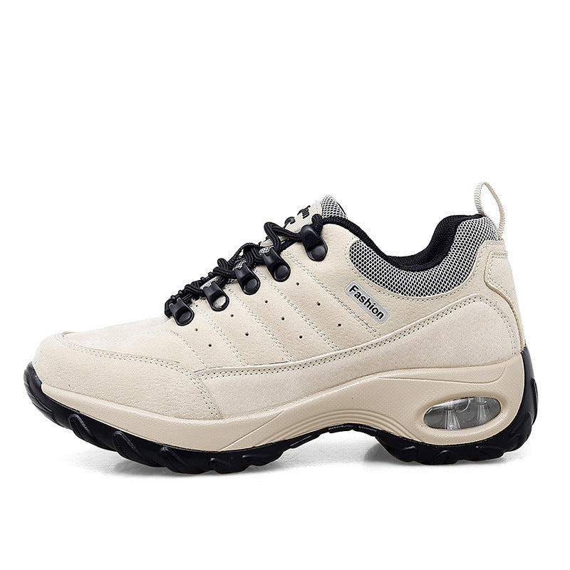 Beige sneaker with black accents on a white background