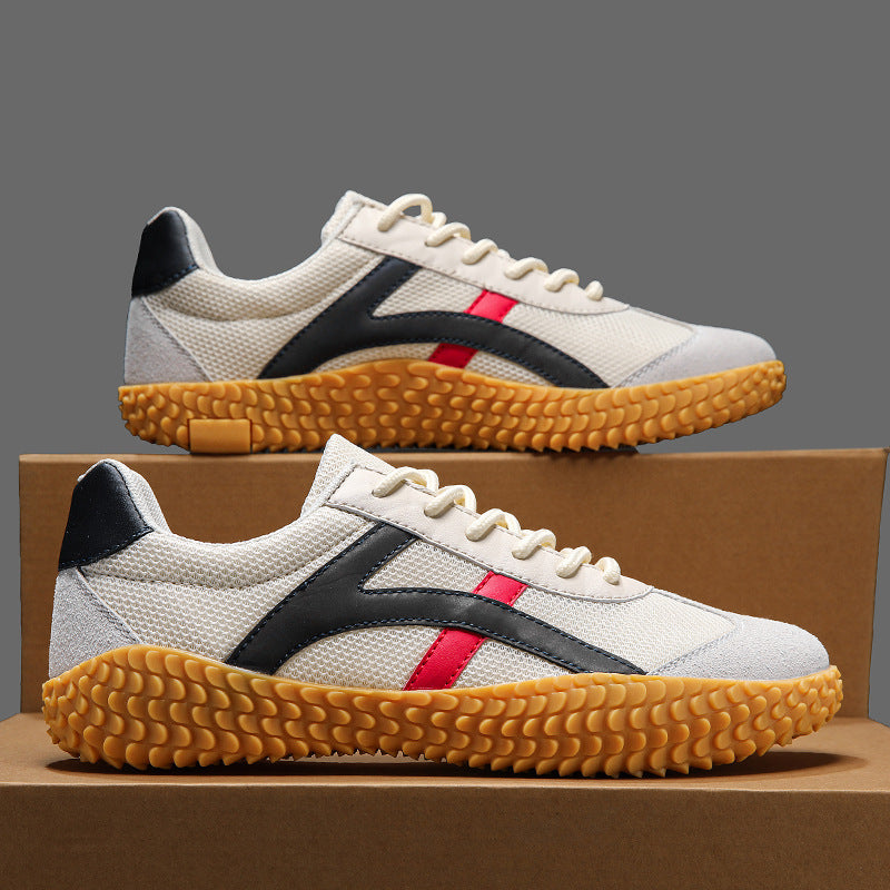 White sneakers with black and red accents on a brown box