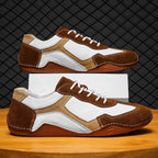 Brown and white sneakers on a wooden surface with a dark textured background