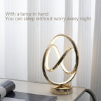 Modern gold lamp on a table with a light background