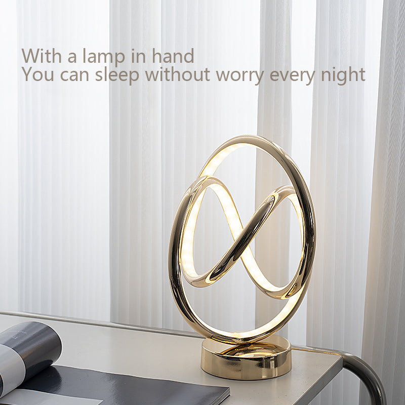 Modern gold lamp on a table with a light background