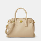 Beige handbag with gold accents on a white background