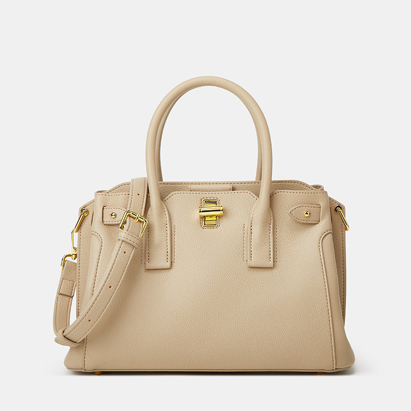 Beige handbag with gold accents on a white background