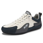 White and navy sneaker with 'Air' branding on a white background