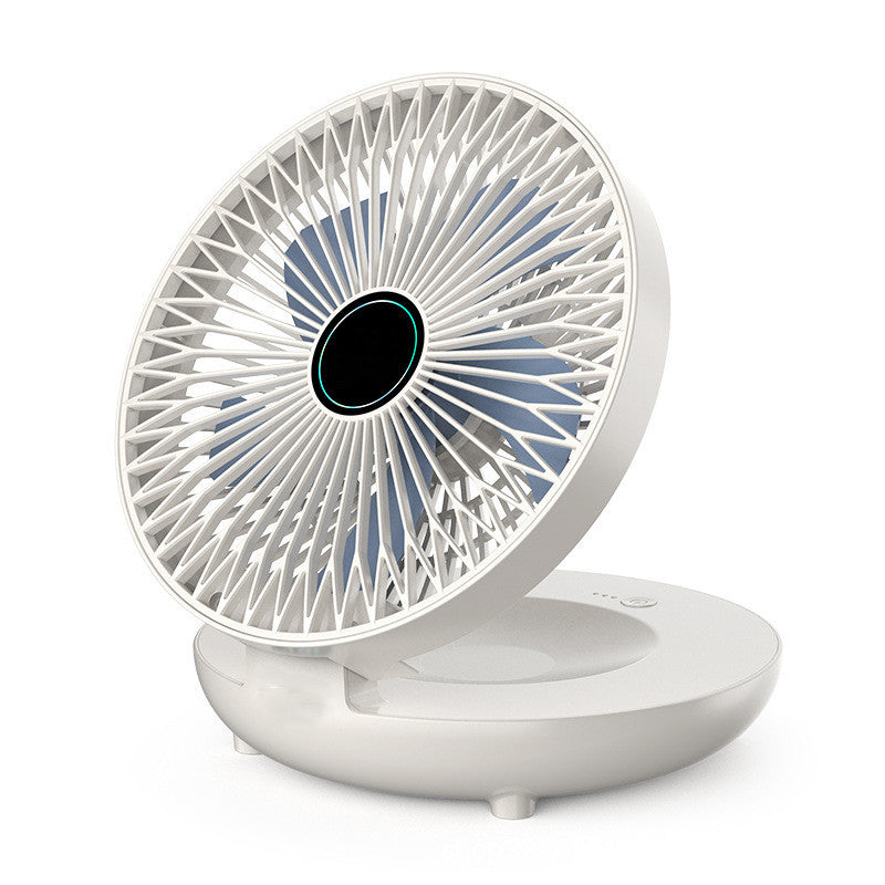 White portable fan with a black center on a white background