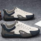 White and gray sneakers with blue accents on a textured surface
