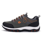 Gray and black sneaker with orange accents on a white background