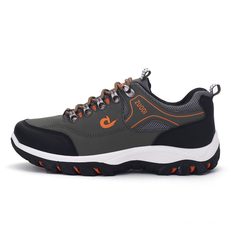 Gray and black sneaker with orange accents on a white background