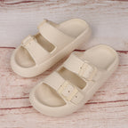 Beige sandals with buckle straps on a wooden surface