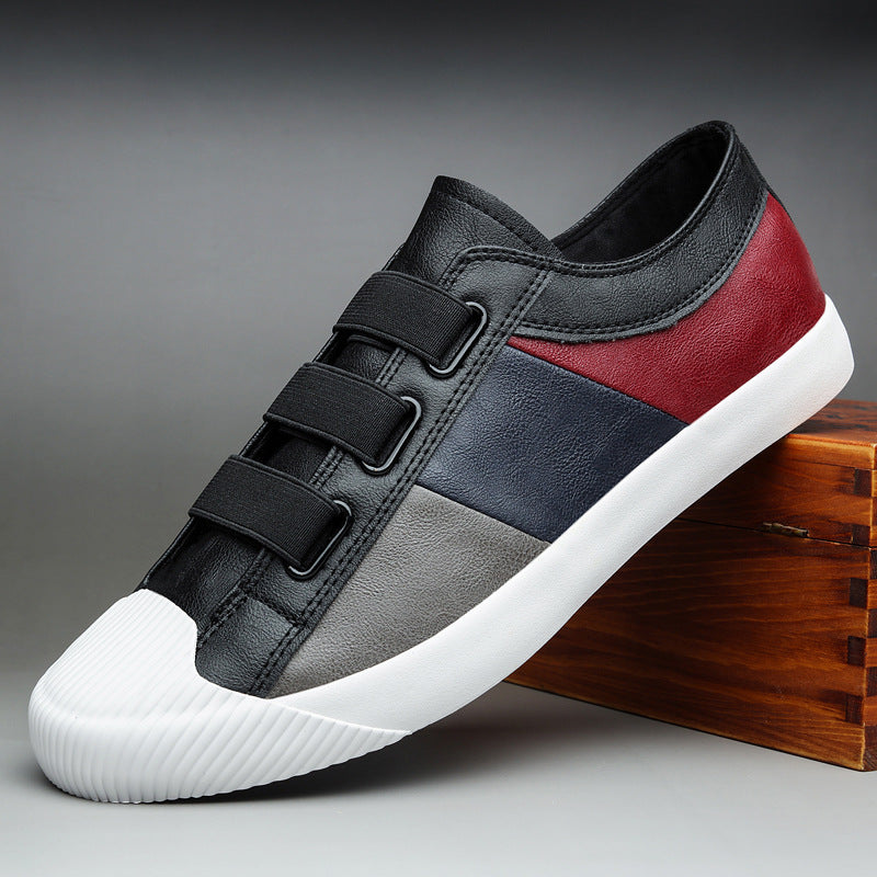 Multicolored sneaker with black, red, and gray design on a gray background