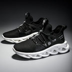Black athletic shoes with white soles on a dark background