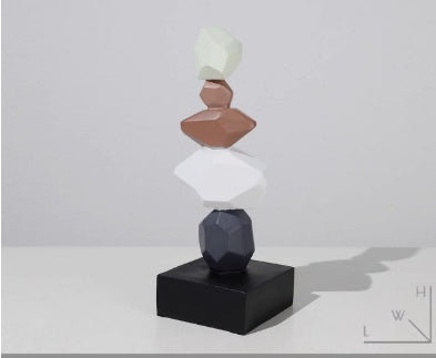 Stack of colorful geometric shapes on a black base against a light gray background
