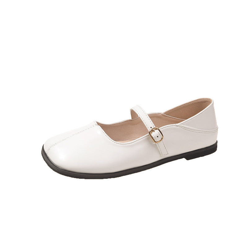 White flat shoe with a strap on a white background