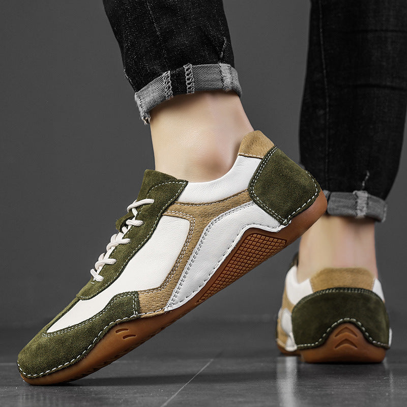 Green and brown sneakers with white accents worn by a person on a dark background