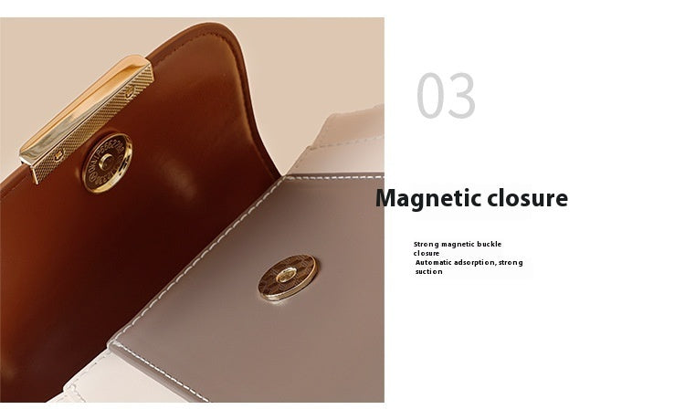 Close-up of a handbag with a magnetic closure feature, showing a gold clasp.