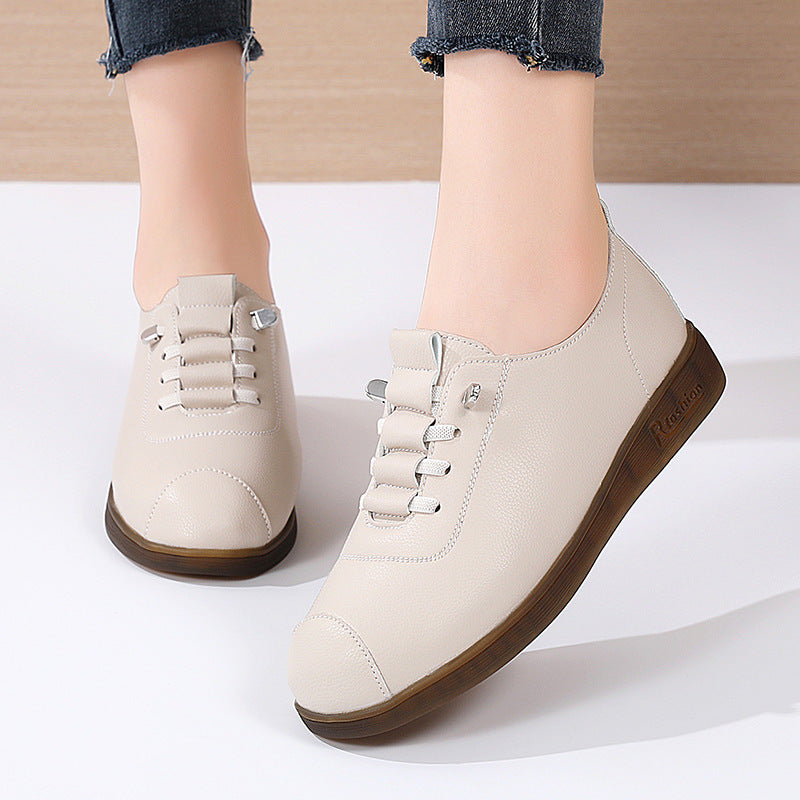White sneakers with brown soles on a white background