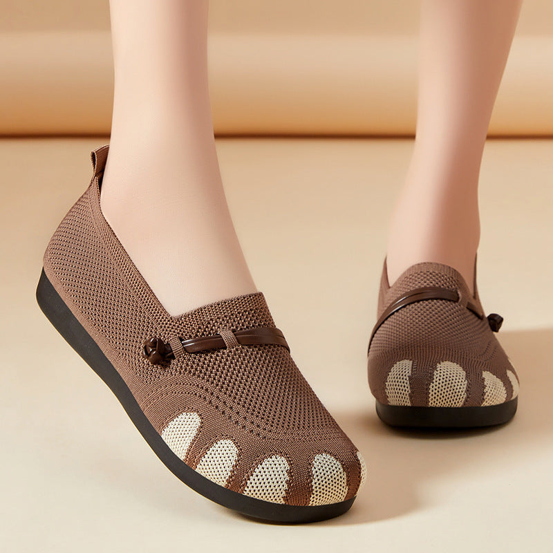 Brown mesh shoes with unique sole design on a beige background