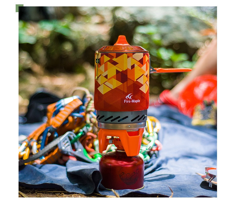 Camping stove with geometric design on a blue cloth outdoors