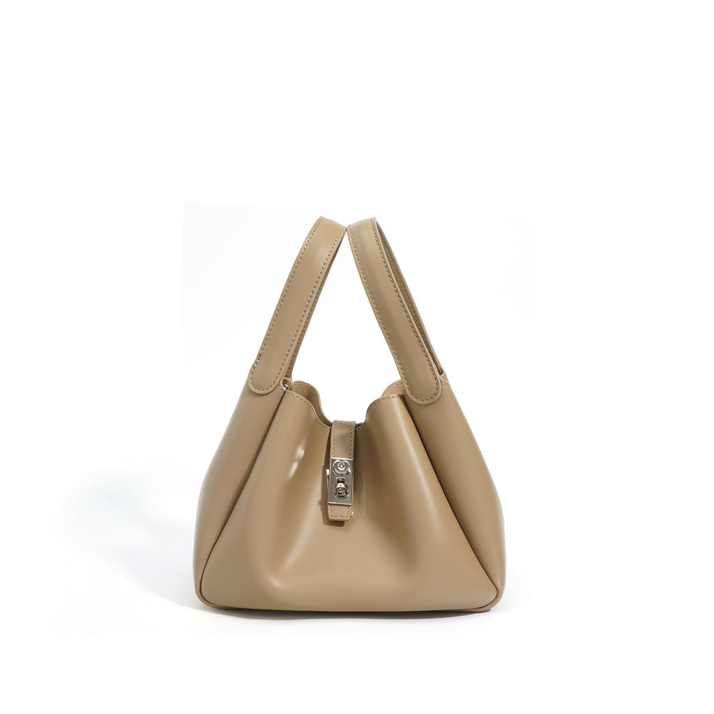 Beige handbag with a silver clasp on a white background