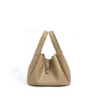 Beige handbag with a silver clasp on a white background