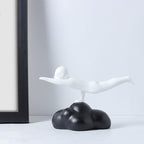 White abstract sculpture on a black base against a white wall