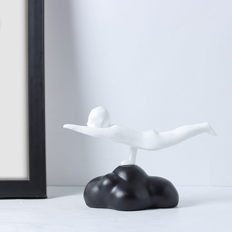 White abstract sculpture on a black base against a white wall