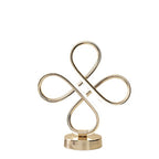 Gold decorative item with interlocking loops on a white background