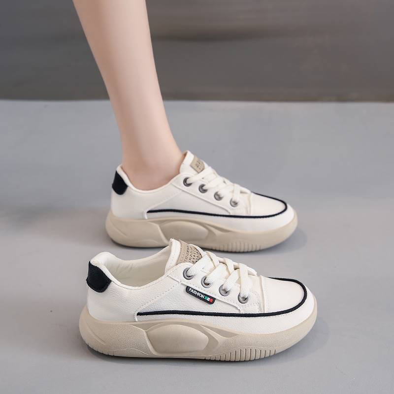 White sneakers with black accents on a gray background