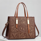 Brown leather handbag with embossed designs on a light gray background