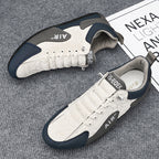 White sneakers with navy accents on a textured surface