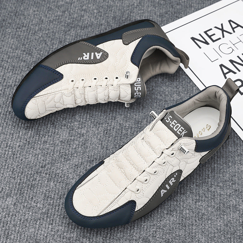 White sneakers with navy accents on a textured surface