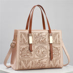 Designer handbag with intricate patterns and brown straps on a light gray background