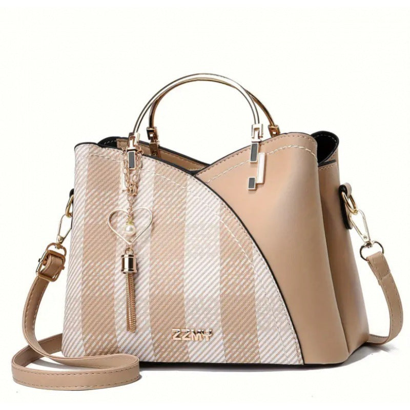 Beige and white striped handbag with gold accents on a white background