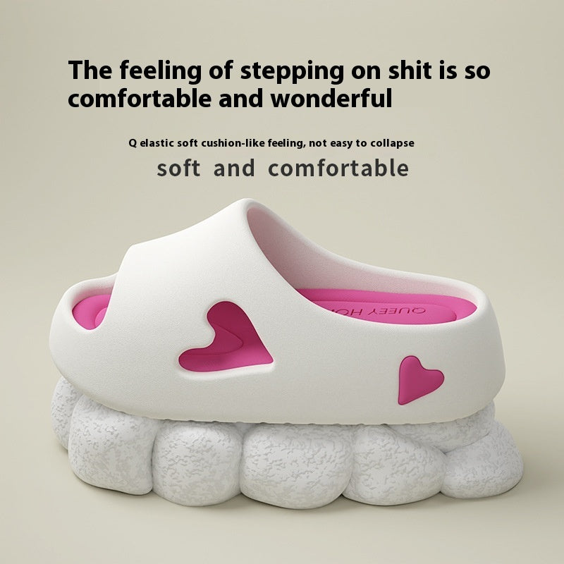 White sandal with pink hearts on a beige background