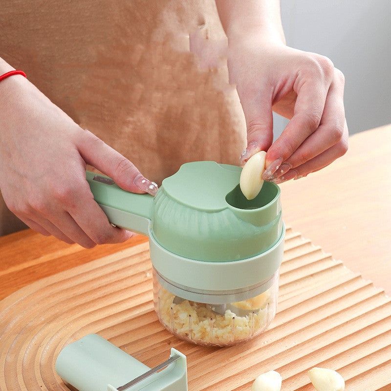 Person using a green garlic press on a wooden surface