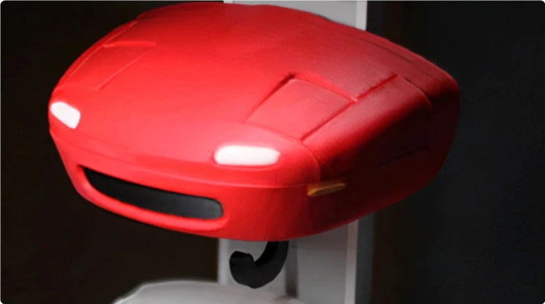 Red plastic object with lights on a dark background