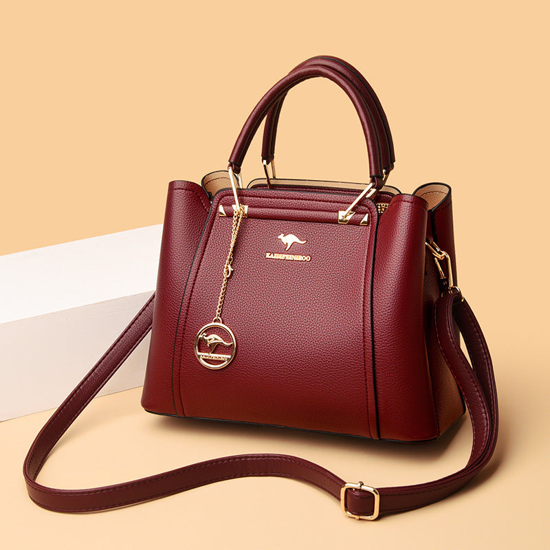 Red handbag with a visible brand logo on a beige background