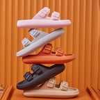 Stack of colorful sandals on an orange background