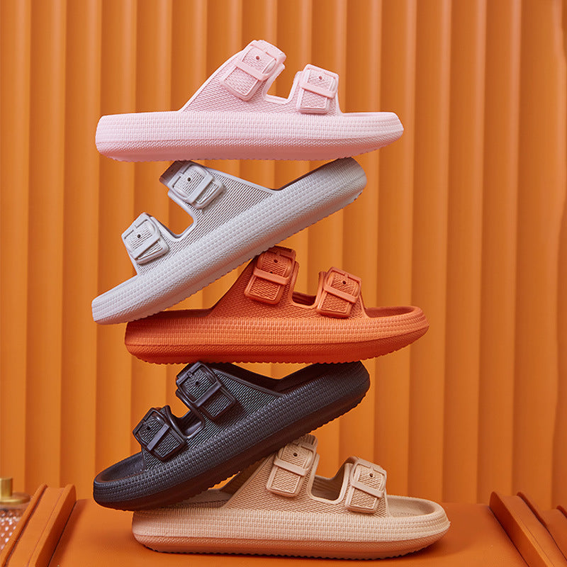 Stack of colorful sandals on an orange background