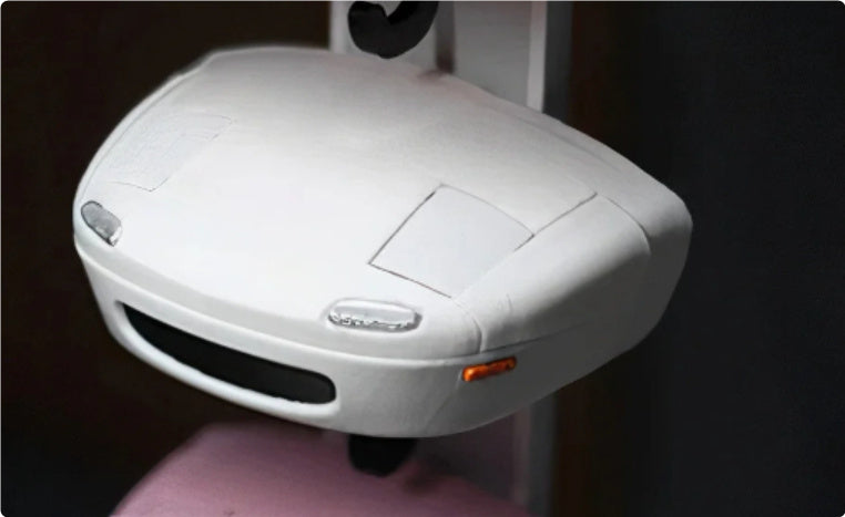 White electronic device on a stand with a dark background