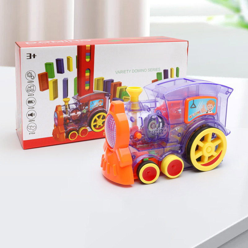 Colorful toy train with transparent car and orange front section, next to its packaging on a white surface.