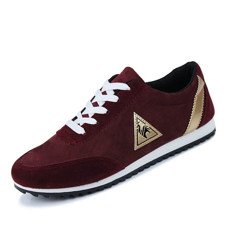 Maroon sneaker with a gold logo on a white background