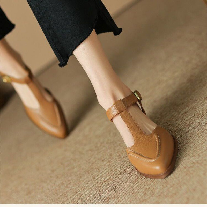 Brown shoes worn on a textured surface