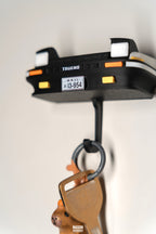 Keychain with a license plate holder attached to a hook on a white background