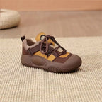 Brown and yellow sneaker on a textured surface