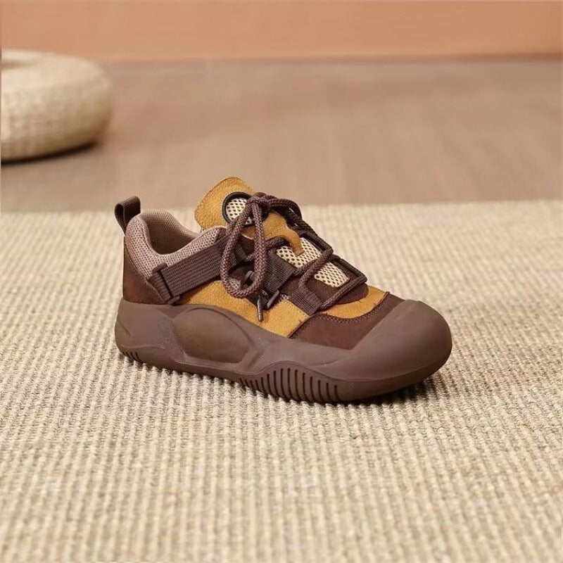 Brown and yellow sneaker on a textured surface