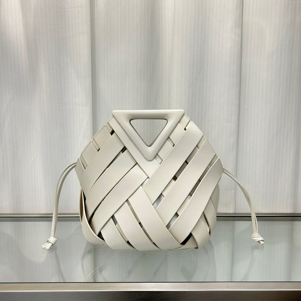 White  leather bag with a geometric design on a reflective surface