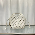 White  leather bag with a geometric design on a reflective surface